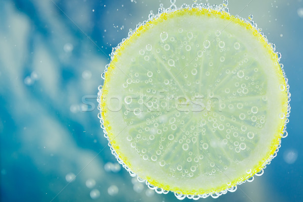 Lemon in carbonated water Stock photo © juniart
