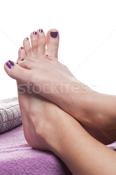 Bare feet with pedicure propped by towel Stock photo © juniart