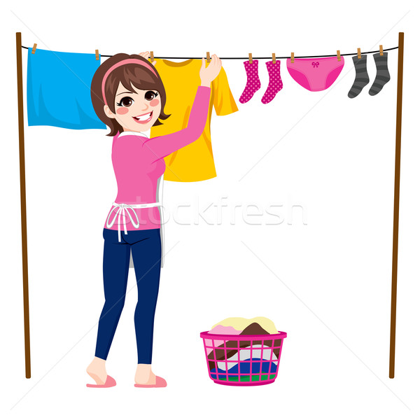 Stock photo: Woman Hanging Clothes