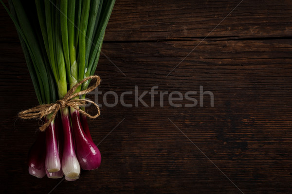 Green onions on wooden table Stock photo © kalozzolak
