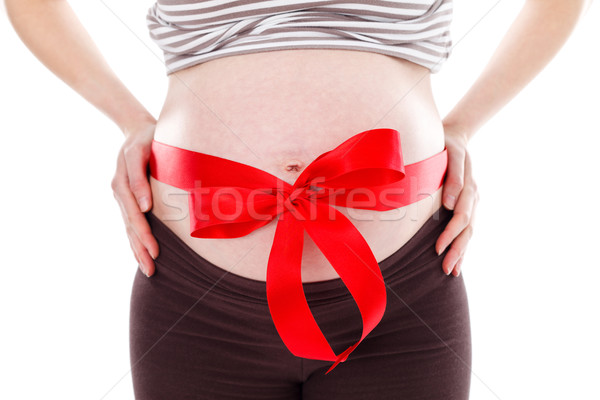 Pregnant woman belly with red bow Stock photo © kalozzolak