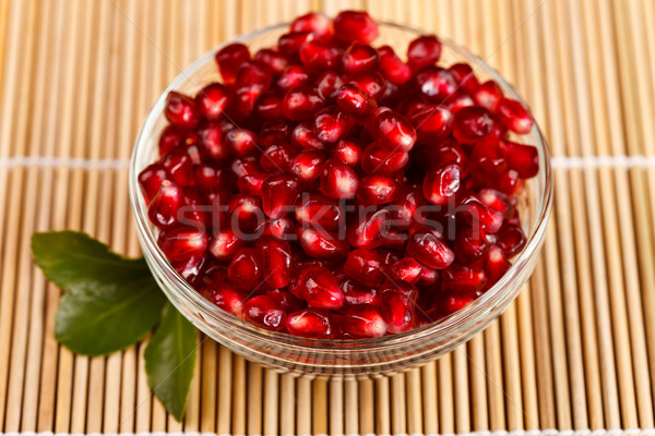 Stock photo: Grenadine seeds with little green leaf