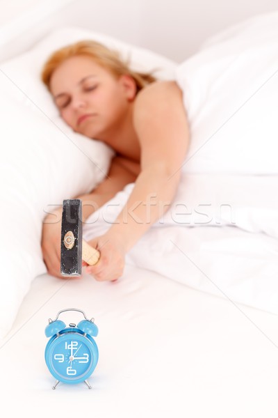 Assonnato donna pigro sveglia martello clock Foto d'archivio © kalozzolak