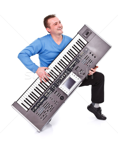 Happy man playing on synthesizer Stock photo © kalozzolak