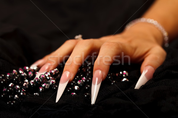 Parels nagels scherp hand geïsoleerd zwarte Stockfoto © kalozzolak