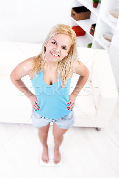 Stock photo: Woman on scale