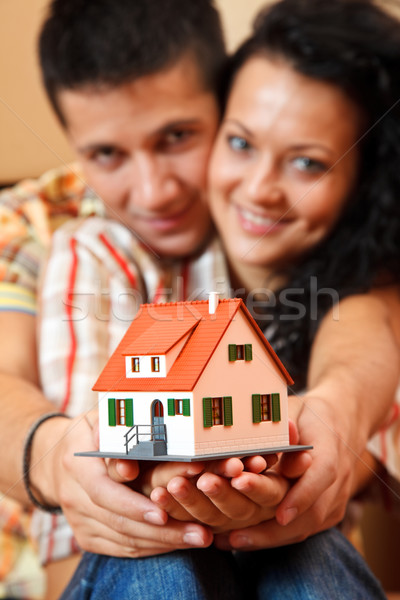 Happy couple with miniature house Stock photo © kalozzolak