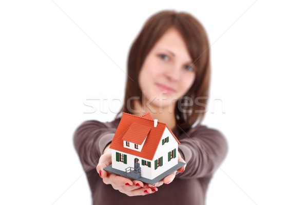 Maison femme offrant miniature symbole nouvelle maison [[stock_photo]] © kalozzolak