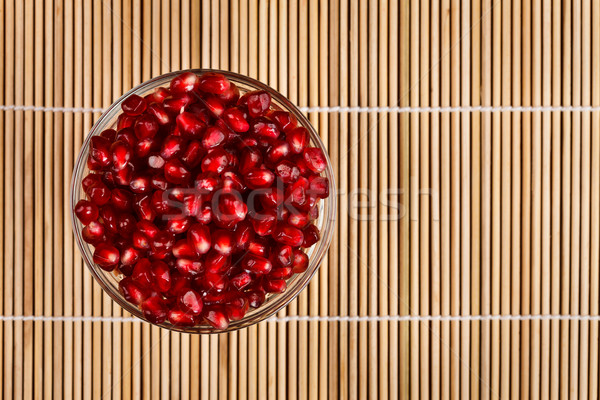 Grenadine seeds in glass bowl, upper view Stock photo © kalozzolak