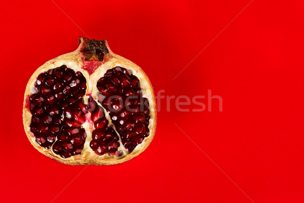 Half grenadine over red background Stock photo © kalozzolak