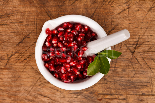 Grenadine seeds in a mortar Stock photo © kalozzolak