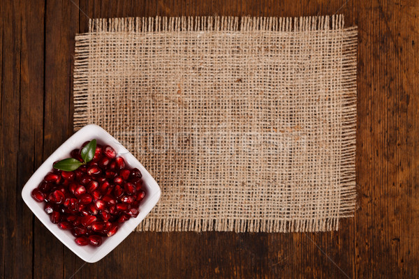 Grenadine seeds in white plate Stock photo © kalozzolak