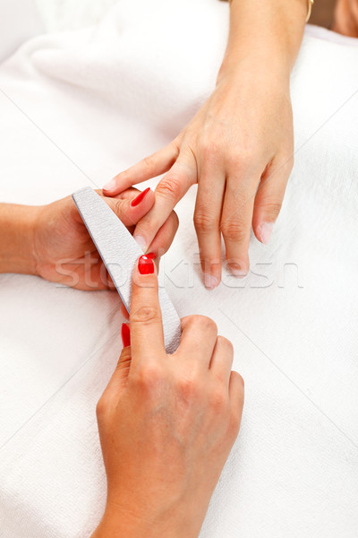 Manicurist filing nail Stock photo © kalozzolak