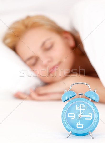 Mujer despertador dormir cama azul Foto stock © kalozzolak