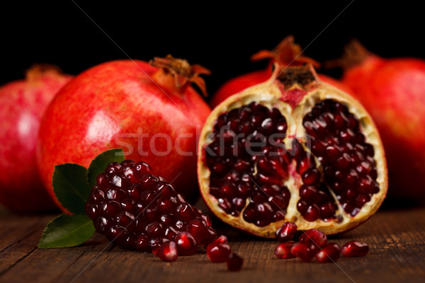 Grenadine fruits and seeds on wooden table Stock photo © kalozzolak