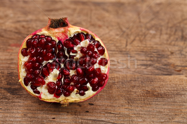 Half grenadine on wooden table Stock photo © kalozzolak