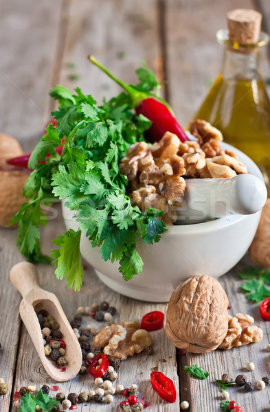 Cilantro and walnuts in a mortar Stock photo © Karaidel