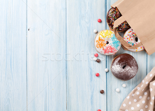 Colorful donuts in paper bag Stock photo © karandaev