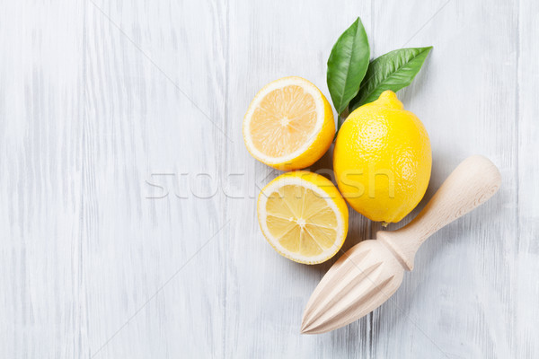 Fresh ripe lemons and juicer Stock photo © karandaev