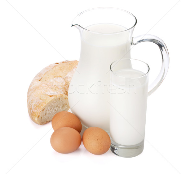 Milk jug, glass, eggs and bread Stock photo © karandaev