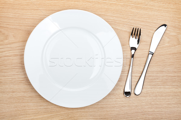üres fehér tányér ezüst étkészlet fa asztal felülnézet Stock fotó © karandaev