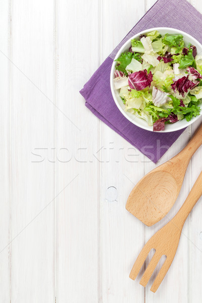 Fresh healthy salad and utensils over white wooden table Stock photo © karandaev