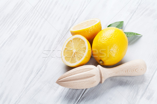 Stock photo: Fresh ripe lemons and juicer