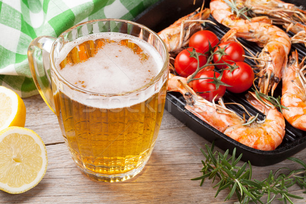 Stock photo: Beer mug and grilled shrimps