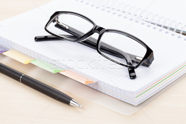 Stock photo: Office table with glasses over notepad