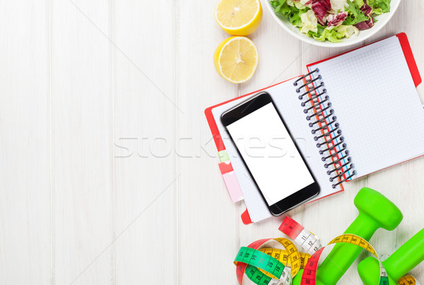 Dumbells, tape measure, healthy food and notepad for copy space Stock photo © karandaev