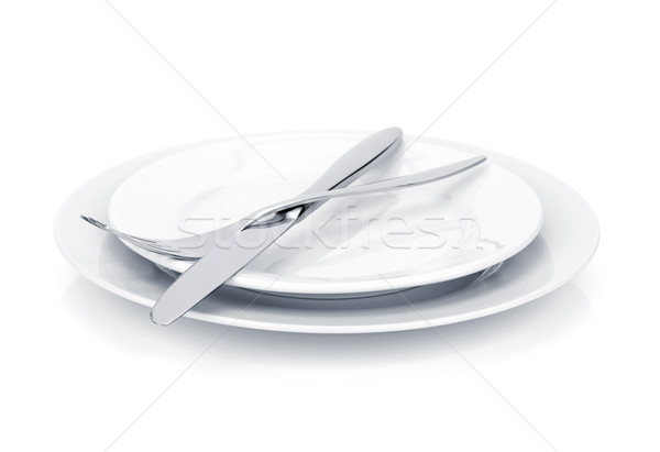 Silverware or flatware set of fork and knife over plates Stock photo © karandaev