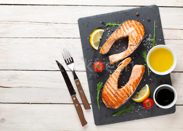 Stock photo: Grilled salmon, salad and condiments on wooden table