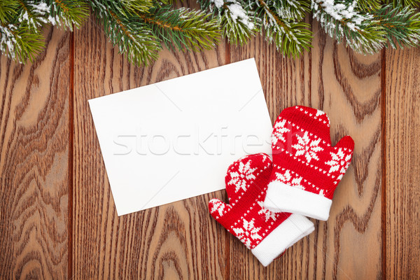 Christmas greeting card or photo frame and mittens over wooden t Stock photo © karandaev