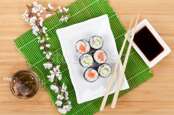 Sushi maki set, green tea and sakura branch Stock photo © karandaev