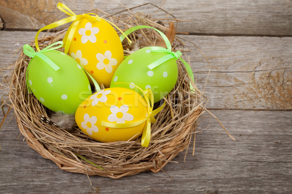 Huevos de Pascua nido mesa de madera naturaleza pintura fondo Foto stock © karandaev