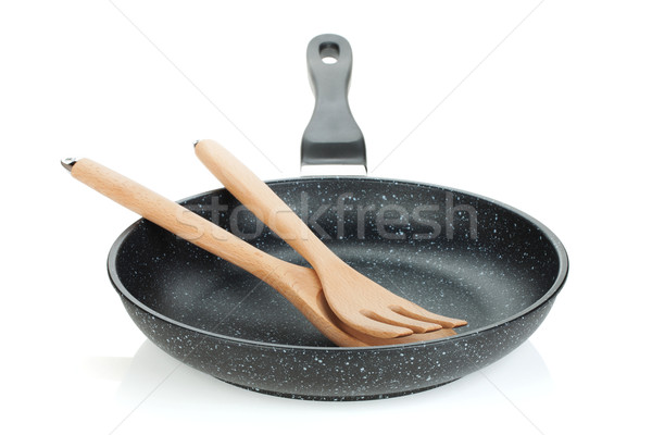 Frying pan with wooden utensils Stock photo © karandaev