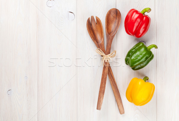 Colorido sino pimentas utensílio de cozinha branco mesa de madeira Foto stock © karandaev