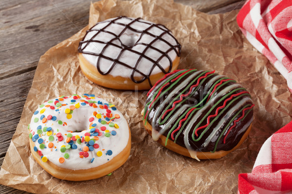 Donuts on wooden table Stock photo © karandaev