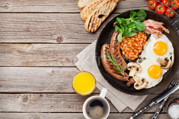 English breakfast. Fried eggs, sausages, bacon Stock photo © karandaev