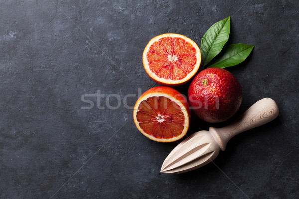 Red oranges and juicer Stock photo © karandaev