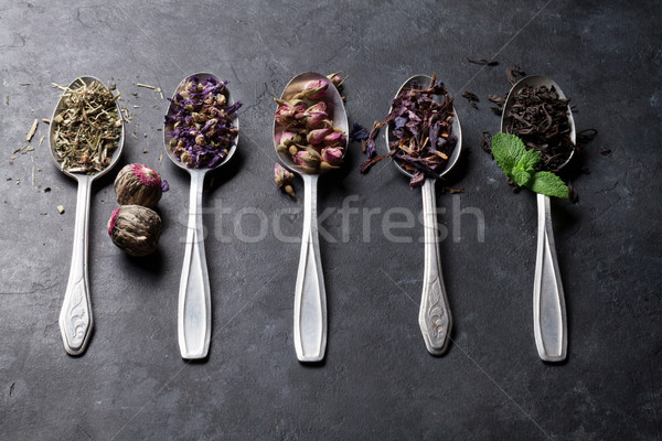 Válogatás száraz tea kanalak kő asztal Stock fotó © karandaev