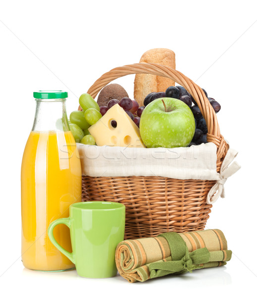 Stock photo: Picnic basket with bread, fruits and orange juice bottle