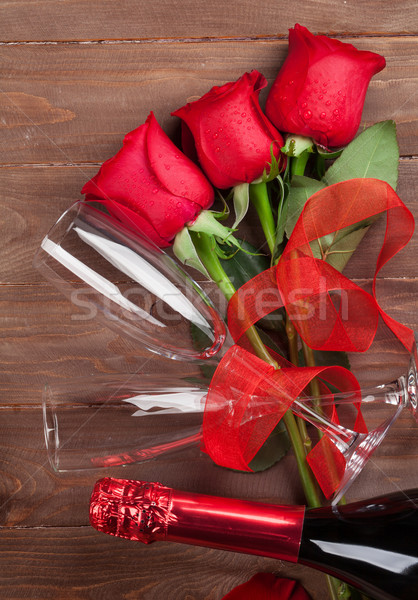 Red roses and champagne Stock photo © karandaev