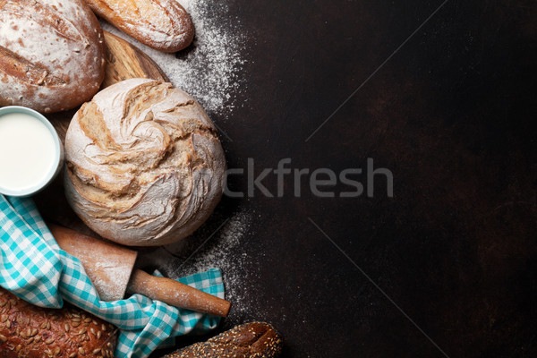 Various crusty bread and buns and milk Stock photo © karandaev