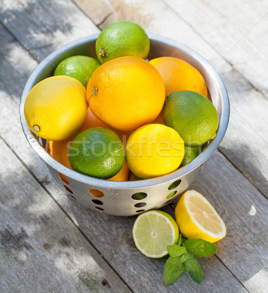 Fresh ripe citruses in colander Stock photo © karandaev