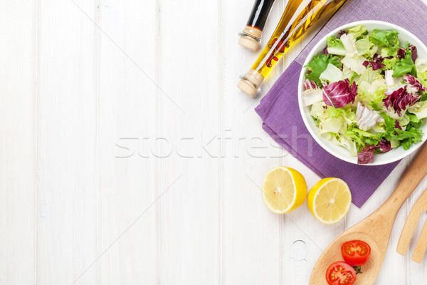 Fresh healthy salad and condiments over white wooden table Stock photo © karandaev