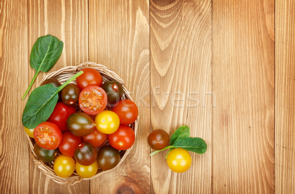 Colorful cherry tomatoes on wooden table Stock photo © karandaev