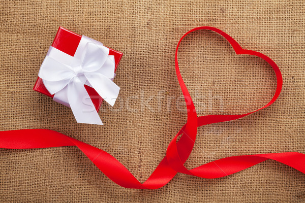 Heart shape ribbon and gift box over burlap valentines day backg Stock photo © karandaev