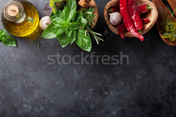 Stock photo: Garden herbs in mortar, oil and chili