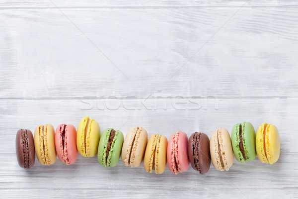 Colorful macaroons on wooden table Stock photo © karandaev